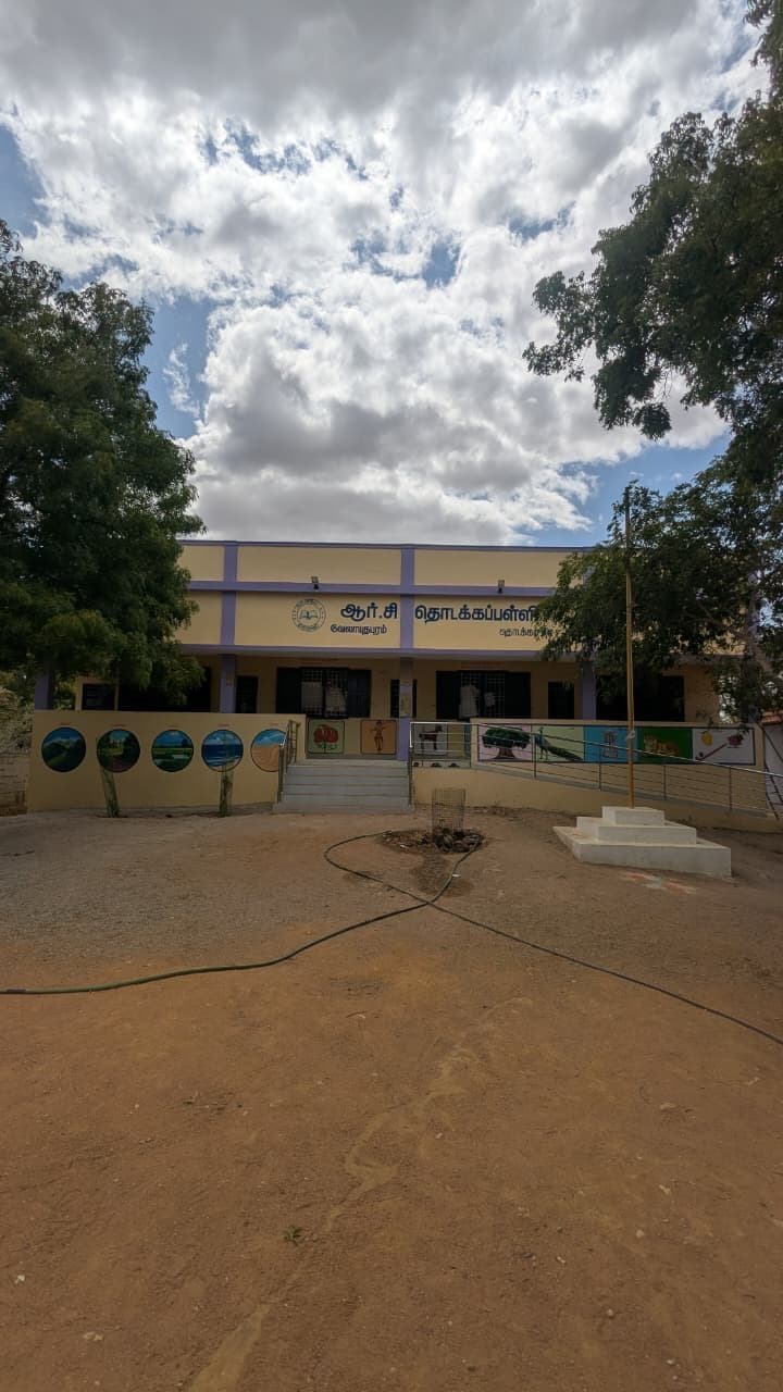 The completed school block seen across the cleared and levelled forecourt.